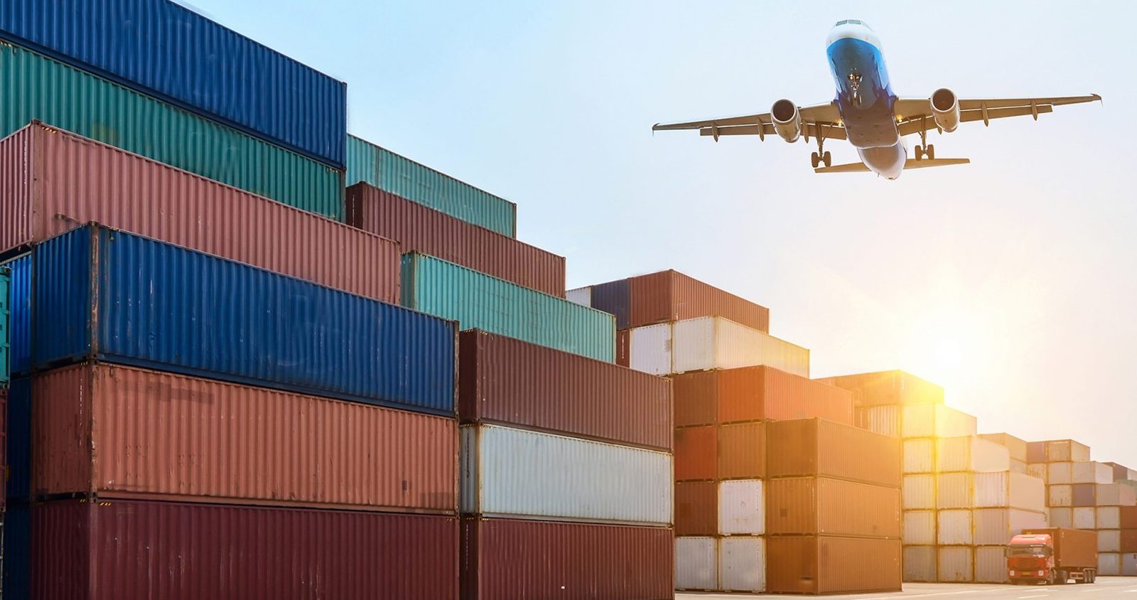 Cargo plane above shipping containers - international freight transport