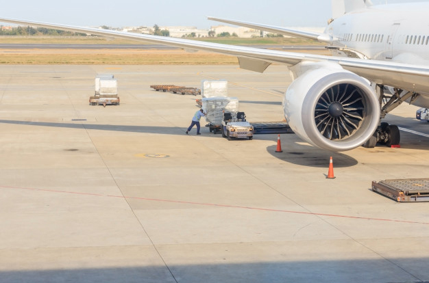 Cargo being loaded next to an aircraft - air freight transport