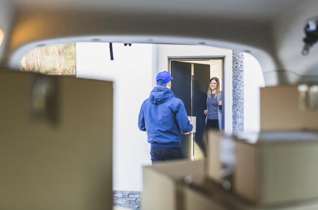 Courier delivering a parcel to the customer's door - parcel delivery